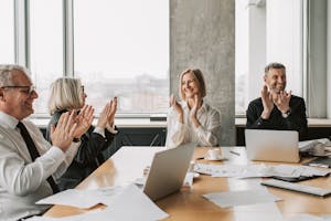 Photo of Adults Clapping while Smiling