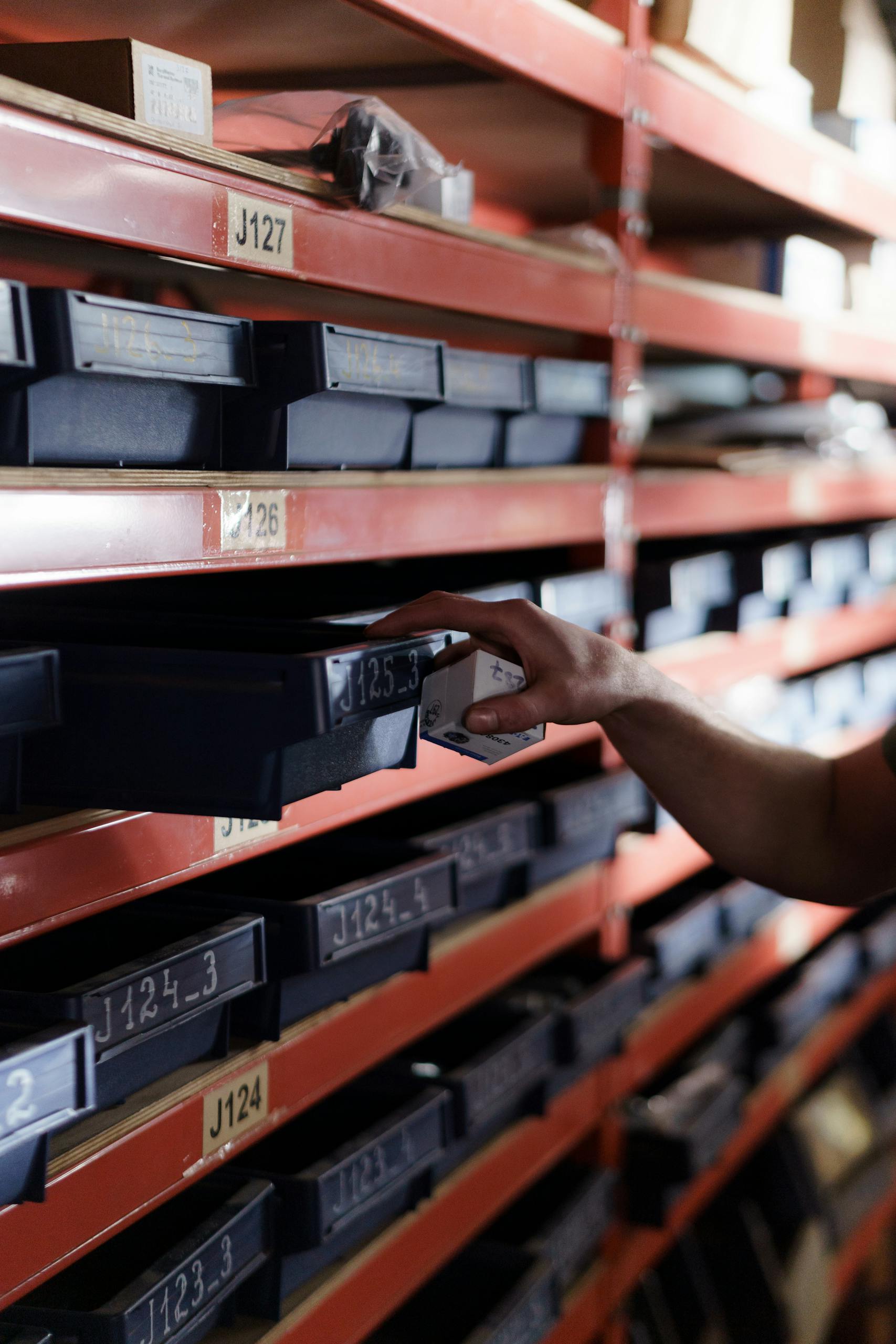 Person pulling Tray from Shelves